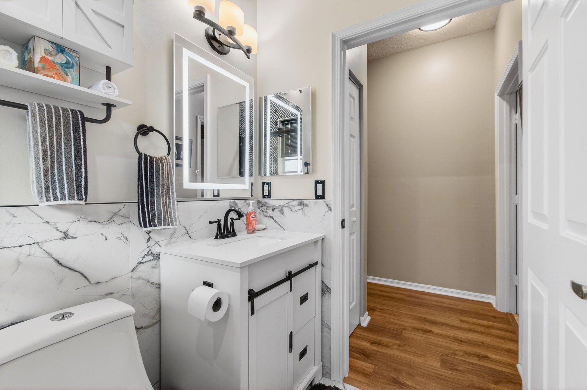 6253 Heliconia Road Delray Beach, FL 33484 - Photo 39 of 85 a bathroom with a sink vanity mirror and toilet
