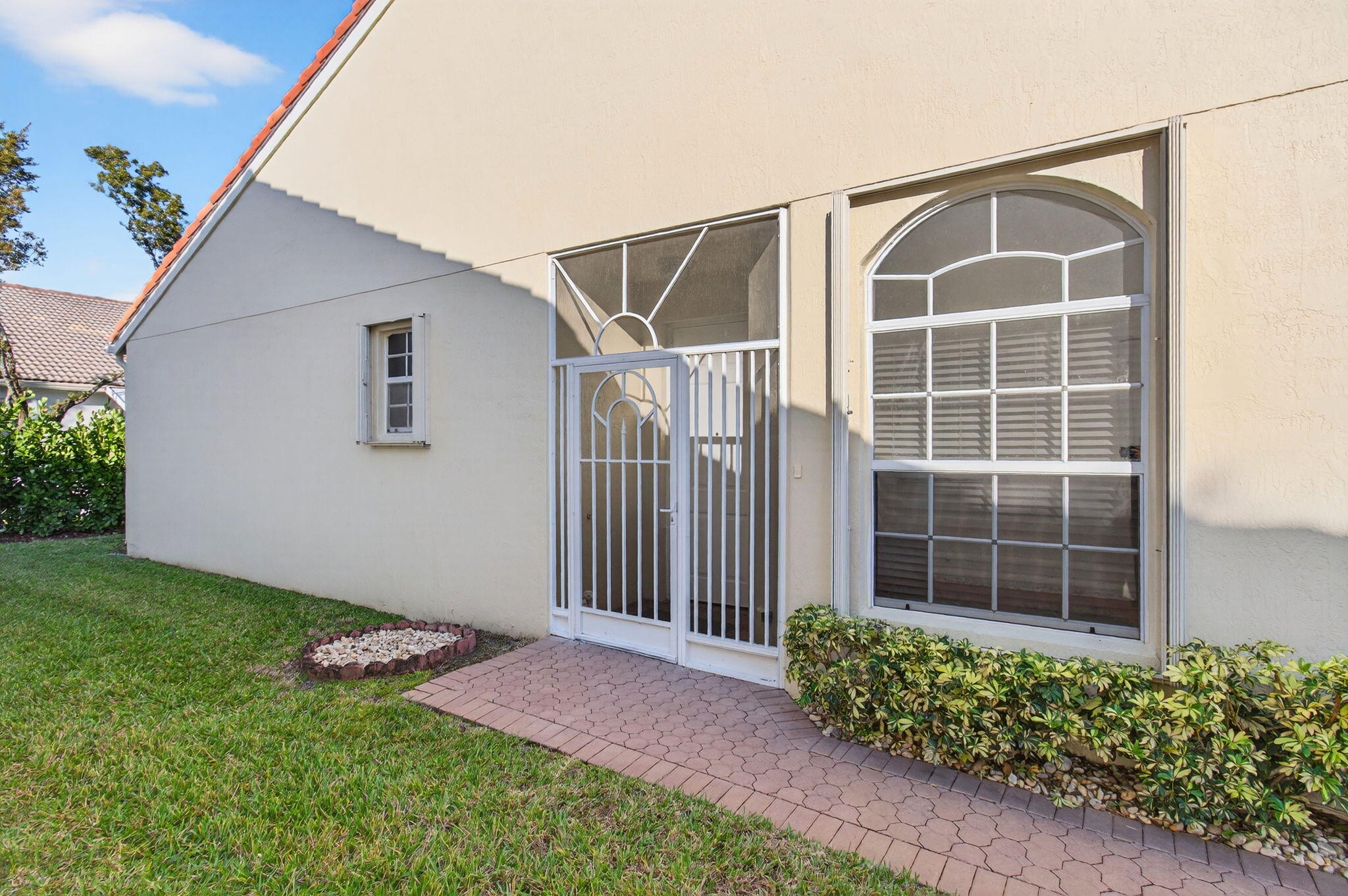 6253 Heliconia Road Delray Beach, FL 33484 - Photo 5 of 85 a front view of a house with a garden