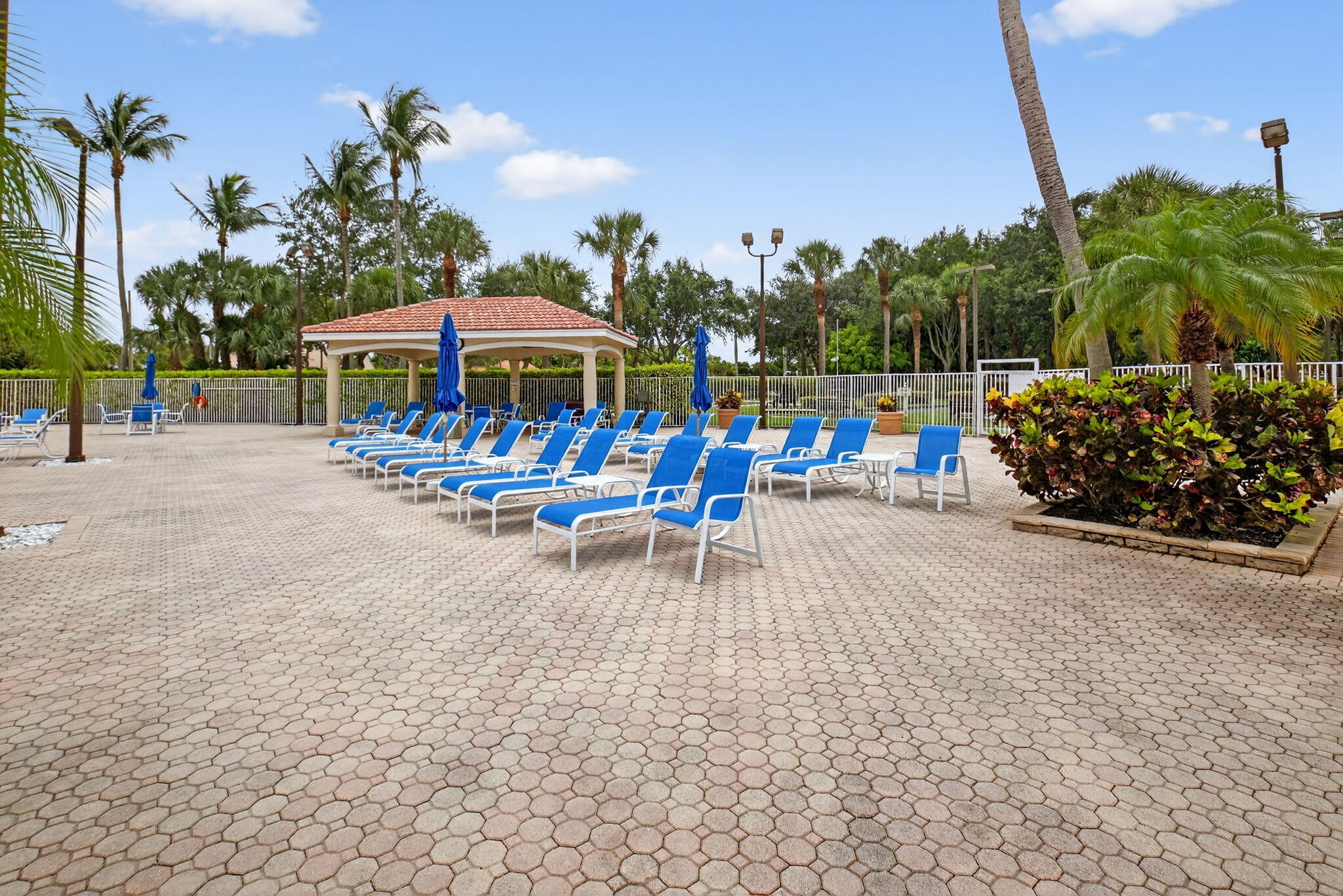 6253 Heliconia Road Delray Beach, FL 33484 - Photo 60 of 85 a view of a patio with a table and chairs under an umbrella