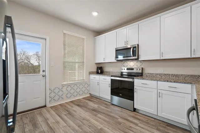 a kitchen with wooden cabinets and a stove top oven