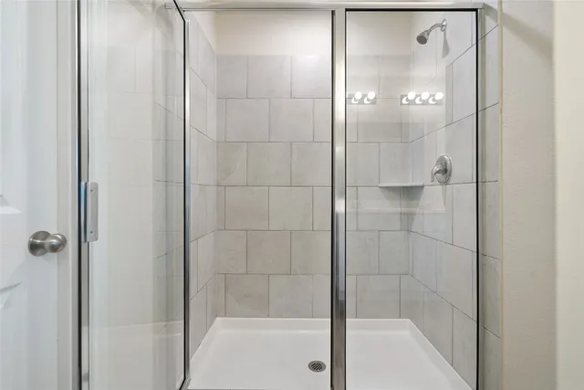 a bathroom with a glass shower door