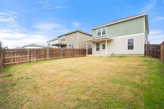 a view of a house with a backyard