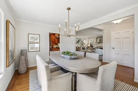 a kitchen with stainless steel appliances granite countertop a sink a stove and a wooden cabinets