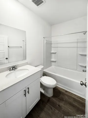 a bathroom with a sink toilet a mirror and shower