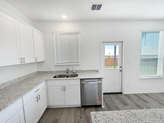 a kitchen with sink and cabinets