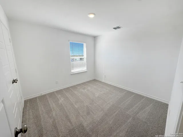 a view of an empty room and a window