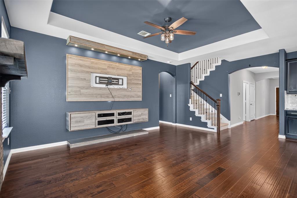 2066 Avondown Road Forney, TX 75126 - Photo 11 of 33 Living area featuring dark wood-finish flooring and a tray ceiling