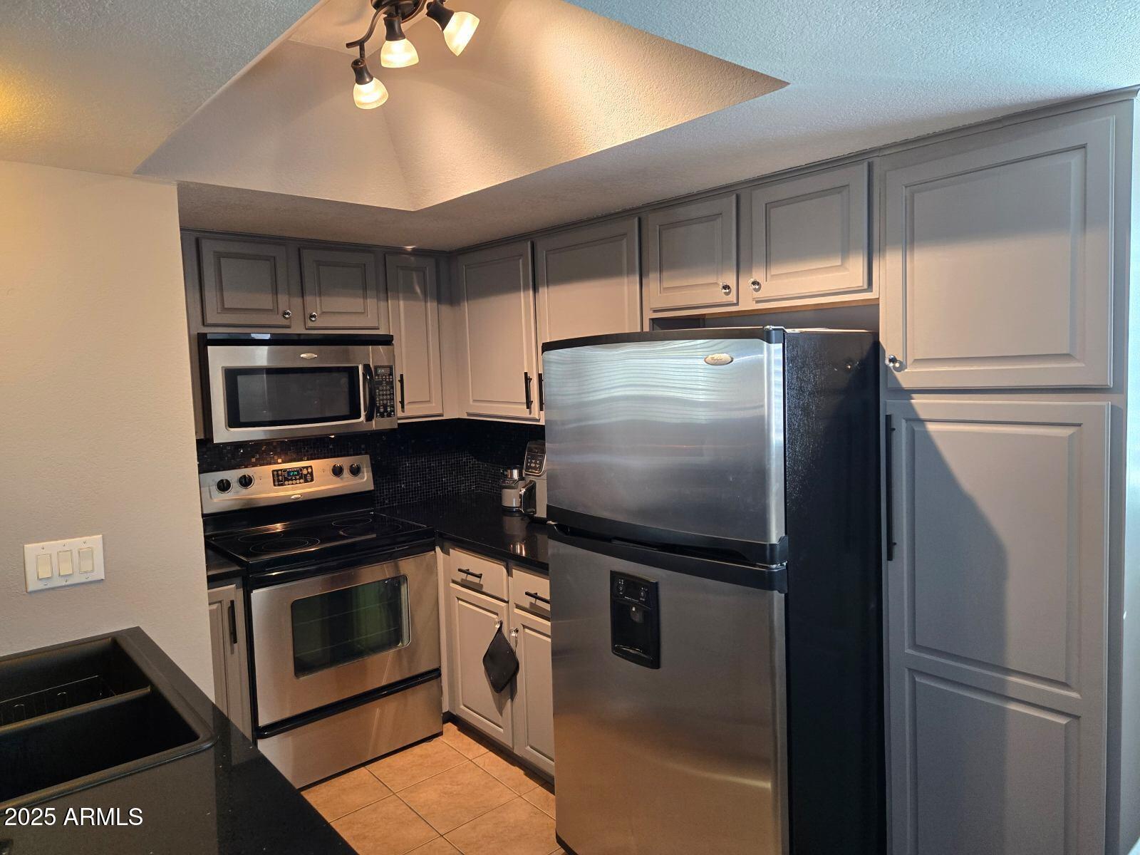 1720 East Thunderbird Road, Unit 2015 Phoenix, AZ 85022 - Photo 16 of 25 a kitchen with metallic refrigerator and microwave