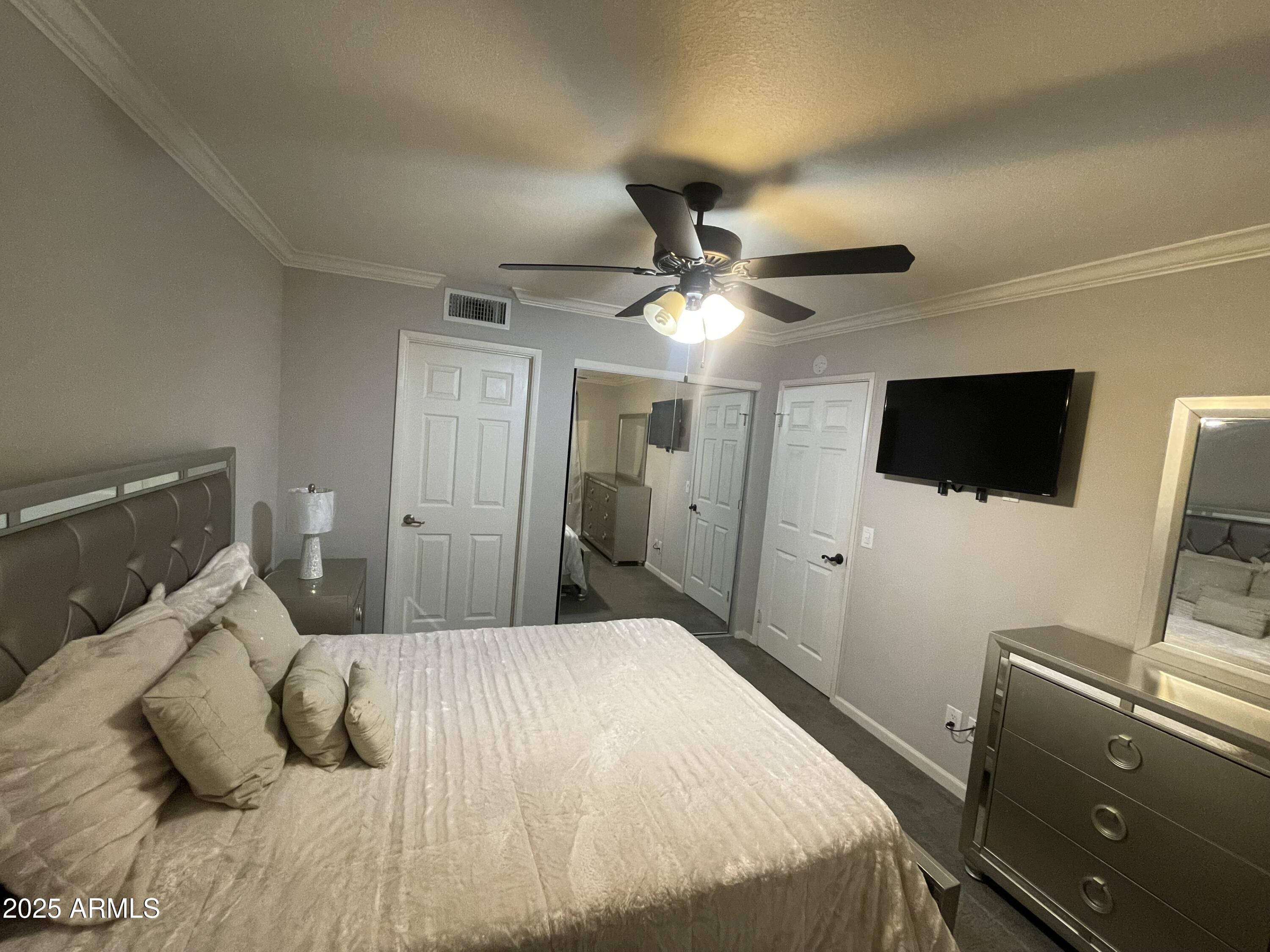 1720 East Thunderbird Road, Unit 2015 Phoenix, AZ 85022 - Photo 17 of 25 a bedroom with a bed and a flat screen tv