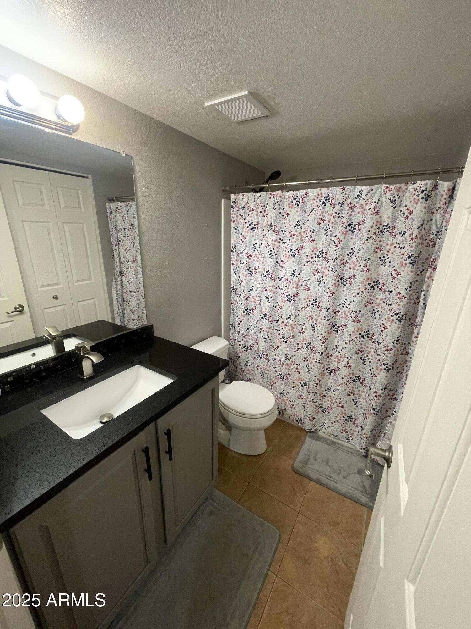 1720 East Thunderbird Road, Unit 2015 Phoenix, AZ 85022 - Photo 18 of 25 a bathroom with a granite countertop sink and a mirror