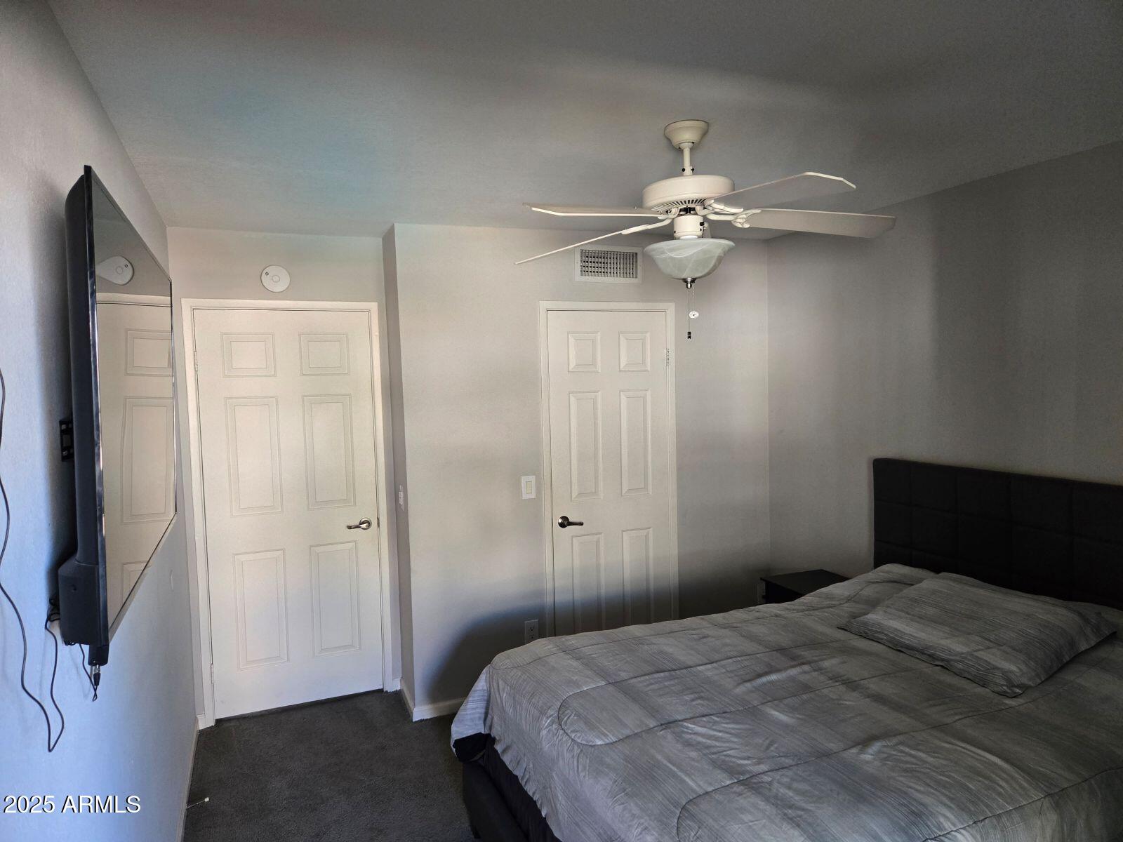 1720 East Thunderbird Road, Unit 2015 Phoenix, AZ 85022 - Photo 19 of 25 a bedroom with a bed and a chandelier