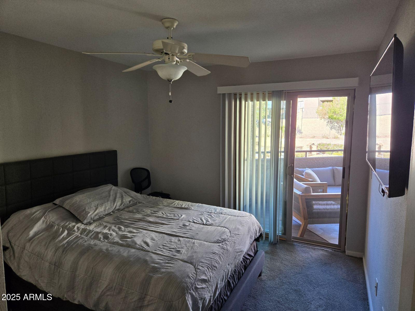 1720 East Thunderbird Road, Unit 2015 Phoenix, AZ 85022 - Photo 20 of 25 a bedroom with a bed and a chandelier