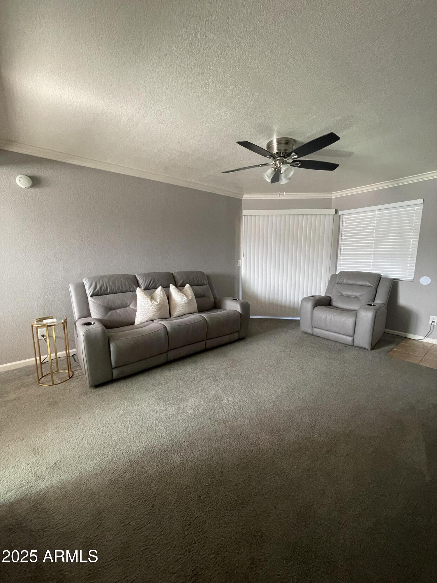 1720 East Thunderbird Road, Unit 2015 Phoenix, AZ 85022 - Photo 8 of 25 a living room with furniture and a ceiling fan