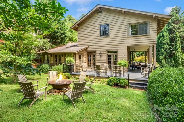 a view of a house with backyard sitting area and garden