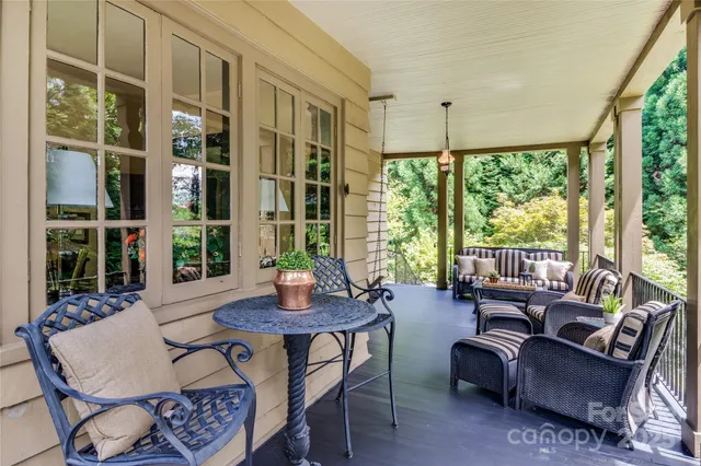a living room with furniture and large windows