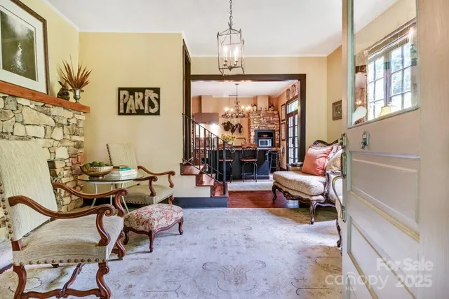 a living room with patio furniture and a chandelier