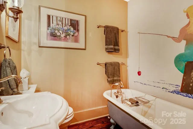 a bathroom with a granite countertop sink a mirror and a toilet