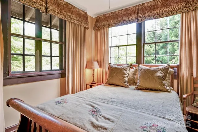 a bedroom with a large bed and a chair