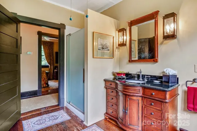 a bathroom with a sink a mirror and a shower