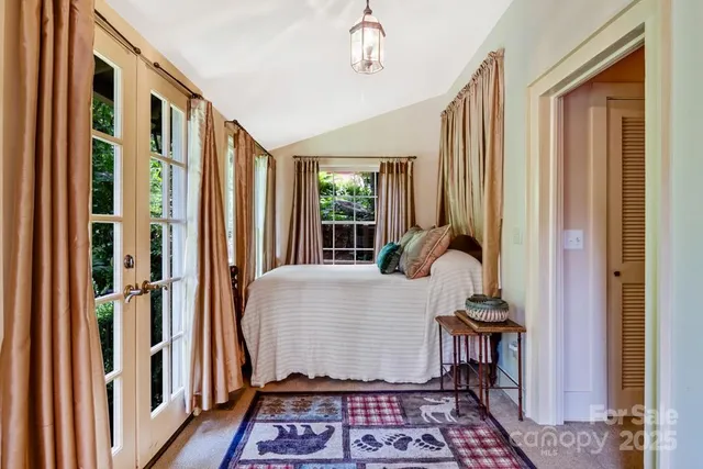 a living room with a rug and a window