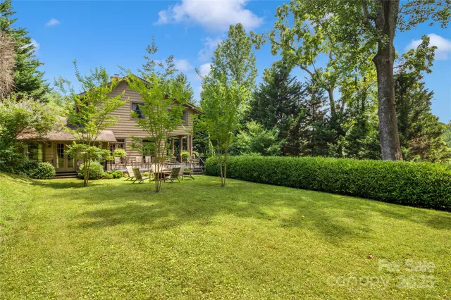 a view of yard with swimming pool and green space