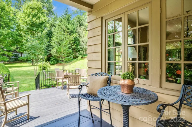 a view of a patio with table and chairs and wooden floor
