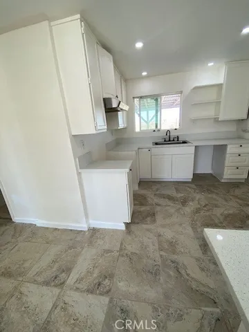 a large kitchen with kitchen island a sink stainless steel appliances and cabinets