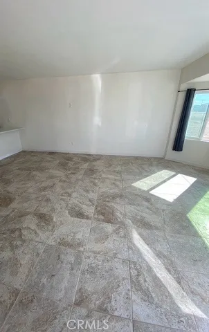 a view of a hallway with wooden floor and stairs