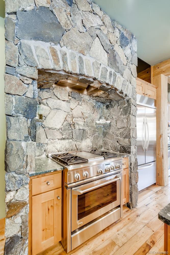 150 Outpost Lane Evergreen, CO 80439 - Photo 16 of 40 a stove top oven sitting inside of a kitchen