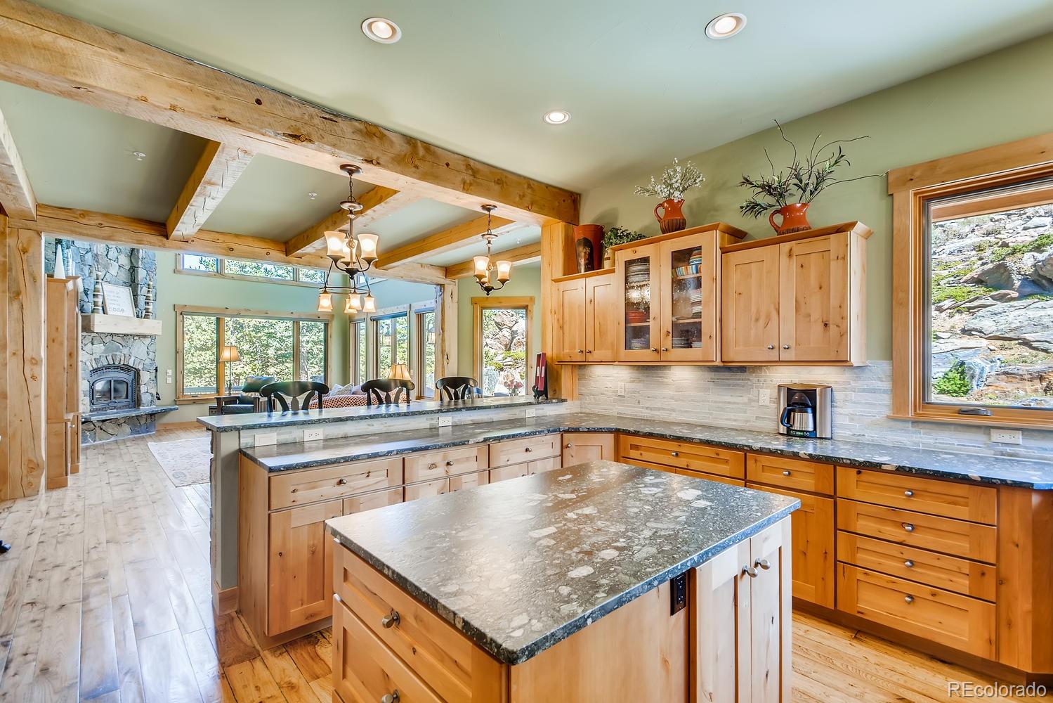 150 Outpost Lane Evergreen, CO 80439 - Photo 17 of 40 a kitchen with stainless steel appliances granite countertop a sink and cabinets