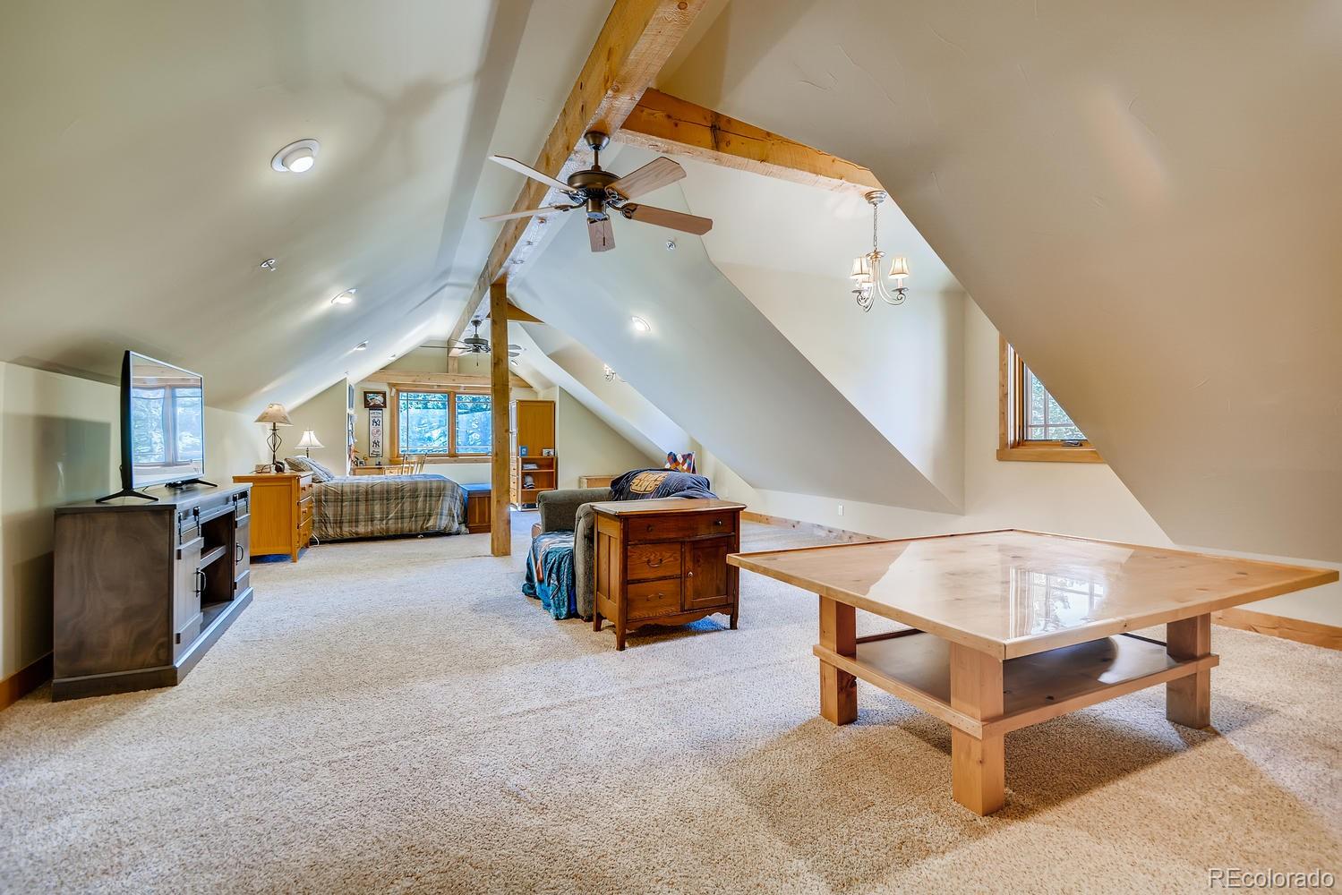 150 Outpost Lane Evergreen, CO 80439 - Photo 30 of 40 a living room with furniture and a table