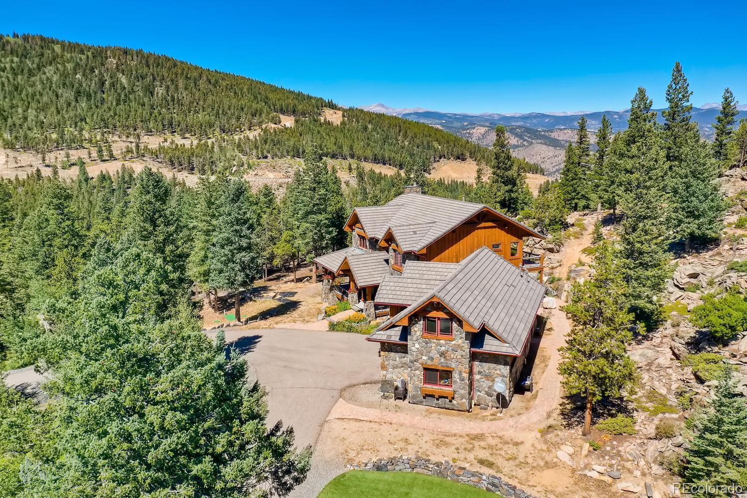 150 Outpost Lane Evergreen, CO 80439 - Photo 3 of 40 an aerial view of a house with swimming pool and mountain view
