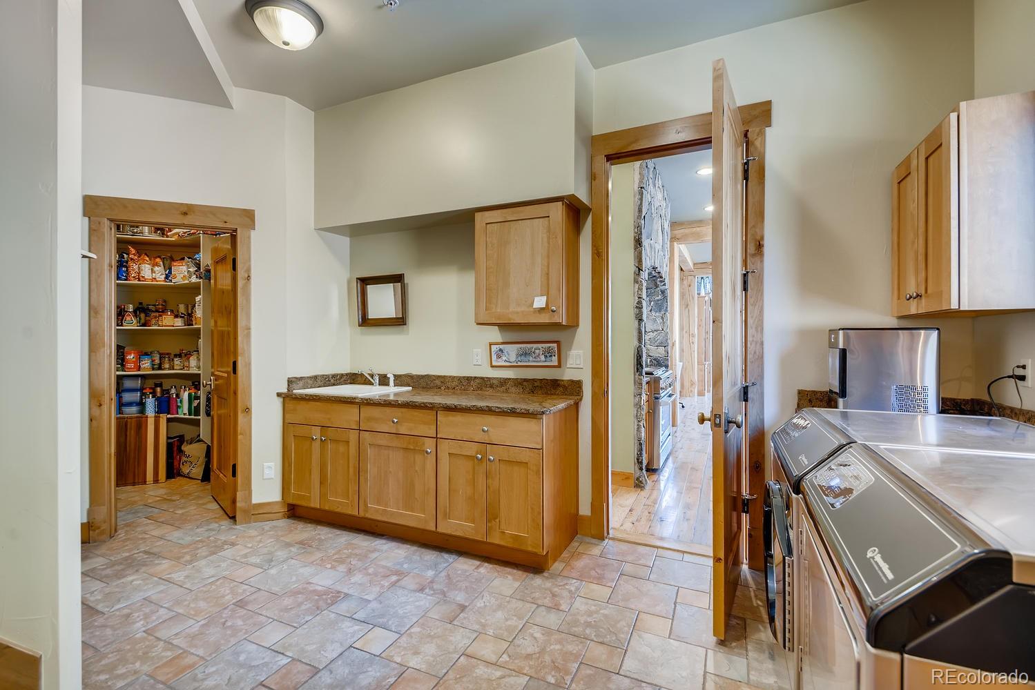 150 Outpost Lane Evergreen, CO 80439 - Photo 32 of 40 a large kitchen with stainless steel appliances granite countertop a stove and a sink