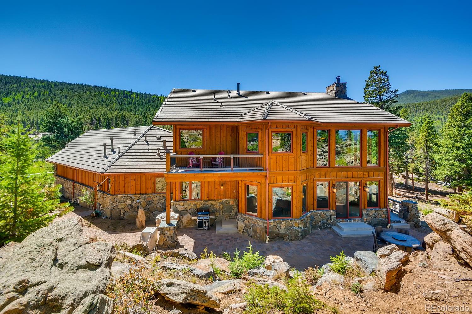 150 Outpost Lane Evergreen, CO 80439 - Photo 35 of 40 a front view of a house with a yard