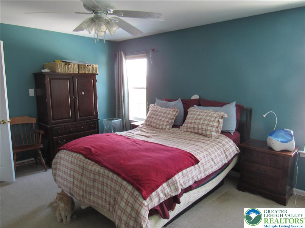 17 Wilt Road Bechtelsville, PA 19505 - Photo 23 of 38 a bedroom with a bed and a chandelier