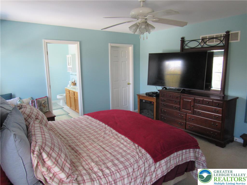 17 Wilt Road Bechtelsville, PA 19505 - Photo 24 of 38 a bedroom with a bed and a flat screen tv