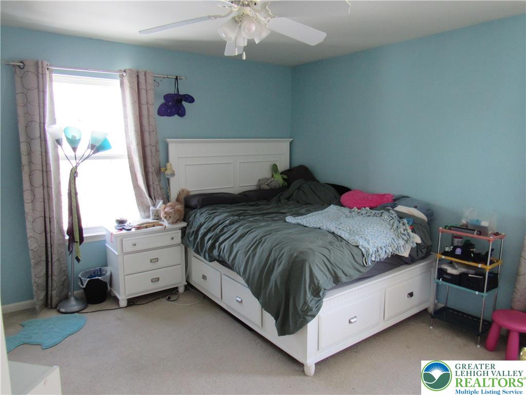 17 Wilt Road Bechtelsville, PA 19505 - Photo 29 of 38 a bed room with a bed and a chandelier