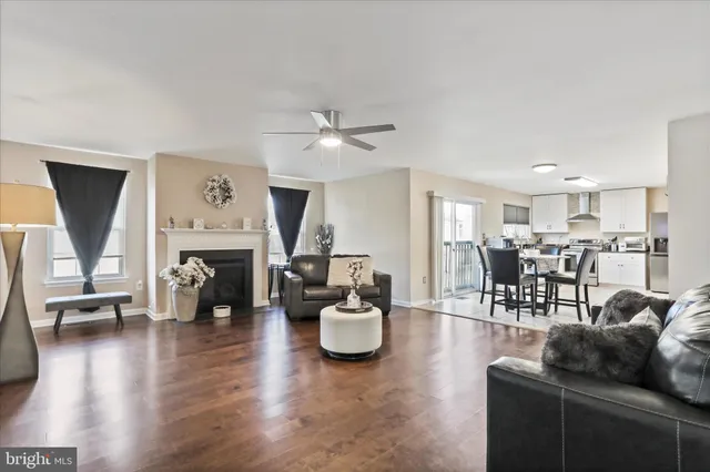 a living room with furniture a fireplace and a large window