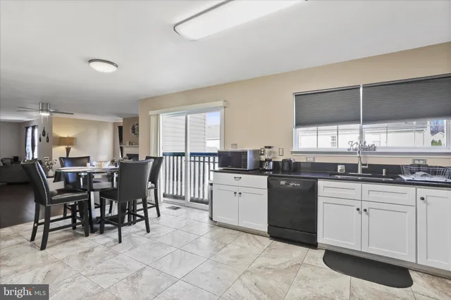 a kitchen with sink a table and chairs