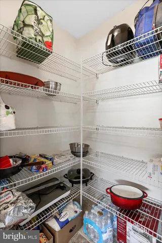 a view of a kitchen with fridge and workspace