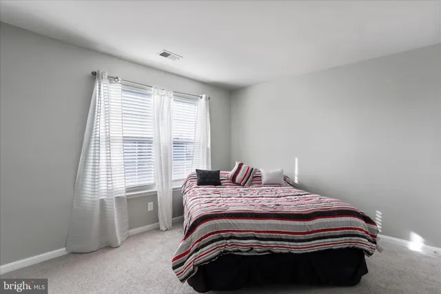 a bedroom with a bed and a lamp