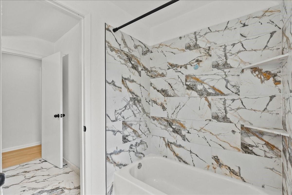 5762 Birdwood Road Houston, TX 77096 - Photo 20 of 49 NOTICE THE GORGEOUS TILED TUB/SHOWER COMBO.