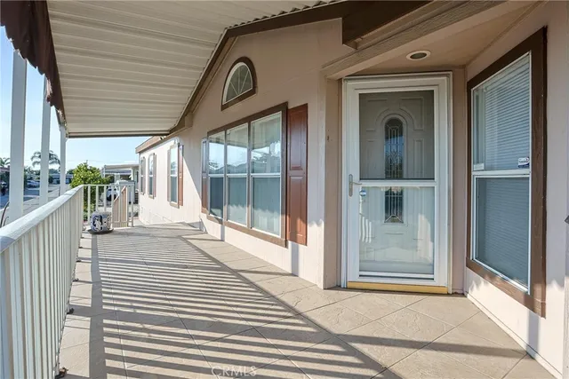 a view of a porch with a door and wooden floor
