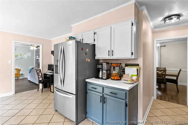 a kitchen with stainless steel appliances a refrigerator and a stove top oven