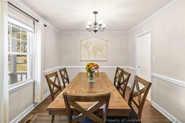 a view of a dining room with furniture window and wooden floor
