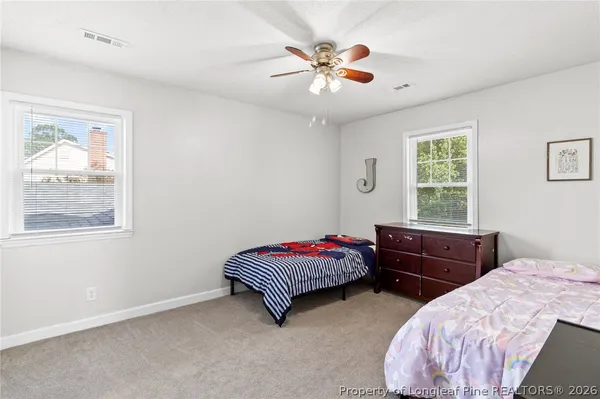 a bedroom with two beds and a chandelier