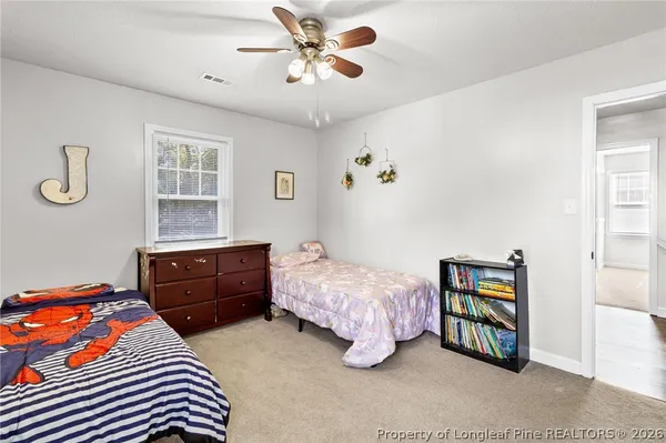 a bedroom with a bed dresser and a window