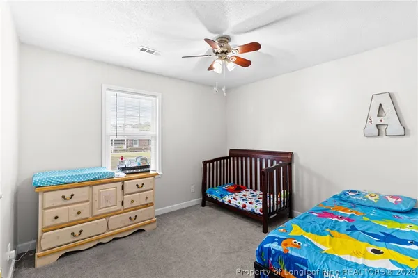 a bedroom with a bed and a baby crib