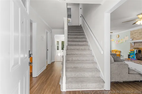 a view of entryway and hall with wooden floor