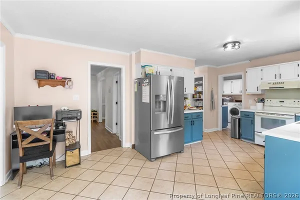 a kitchen with stainless steel appliances a refrigerator and a stove top oven